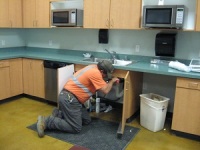 Handyman repairing a kitchen cabinet